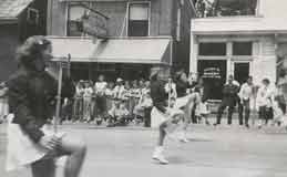 Parade passing in front of Carlton Restaurant and Woody's Bakery